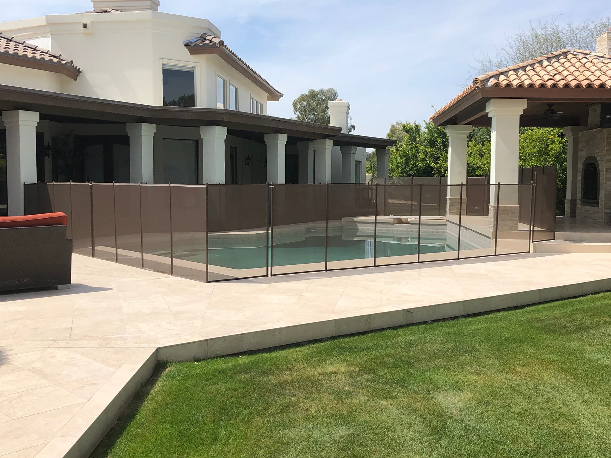 Black mesh pool fence around rectangular pool — residential Arizona backyard
