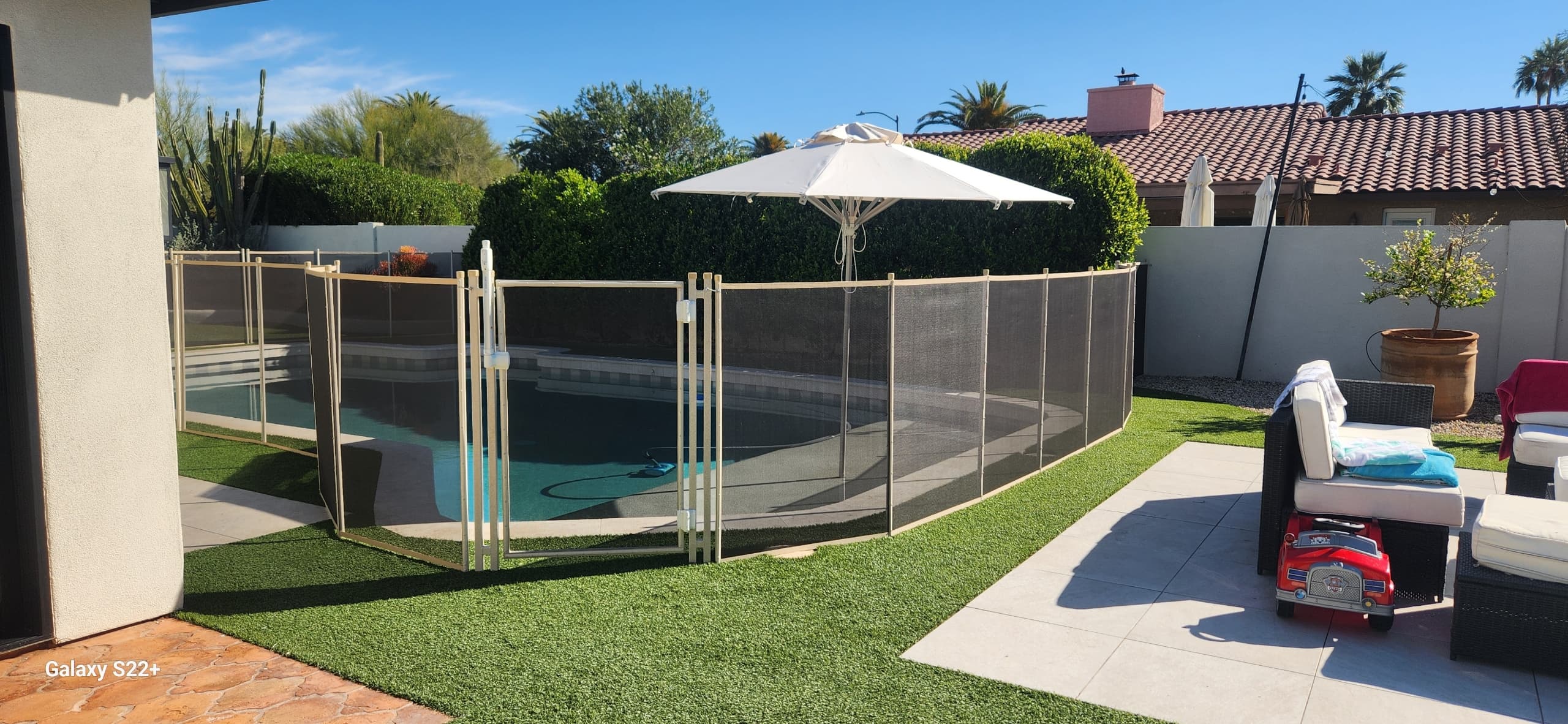 Beige removable pool fence — umbrella, Arizona backyard installation